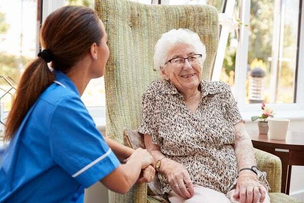 memory-care-nurse-caring-elderly-woman-home